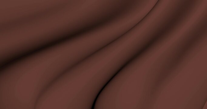 Smooth chocolate cloth moves in waves. A solid background across the entire space of brown fabric in motion. 