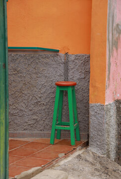 bar stool against grey and orange wall