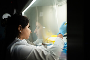 Hispanic Woman Working In A Science Research Laboratory.