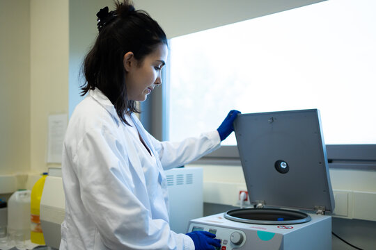 Scientist With White Coat Working With Centrifuge In The Laboratory.