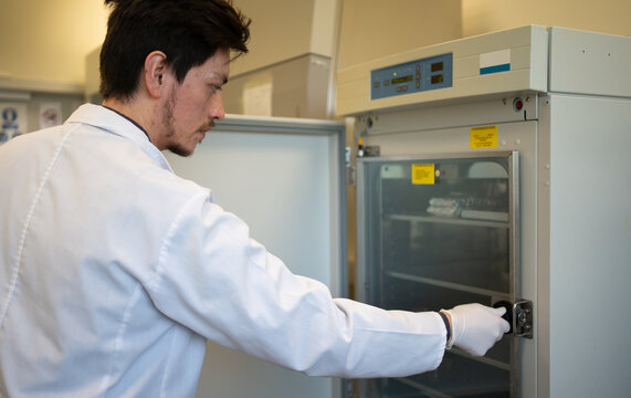 Scientist Opening A Lab Fridge.