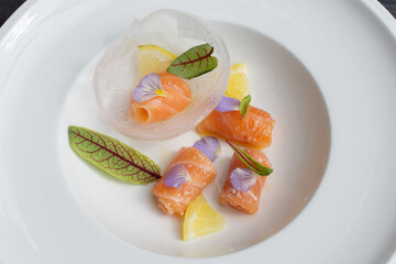 Salmon carpaccio with shio koji, yuzu juice, and olive oil in an ice sphere