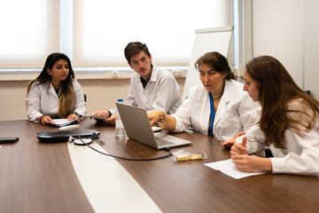 Meeting Of Scientists Discussing Sitting Around The Table.