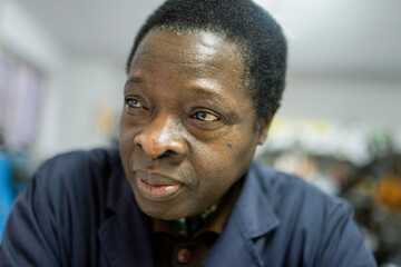 portrait of black man cobbler in his business