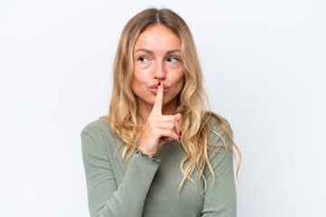 Young Russian woman isolated on white background showing a sign of silence gesture putting finger in mouth