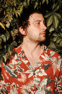 Profile of a man in a shirt in foliage