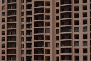 Construction site or building apartment blocks in Oran, Algeria, multiple storeys with new windows and balconies in construction.