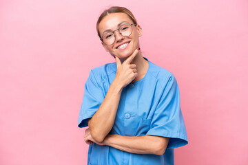 Young nurse doctor woman isolated on pink background smiling