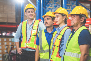 Portrait of successful logistics warehouse workers team, Group portrait of industry workers, Workers in hardhat helmet at workplace