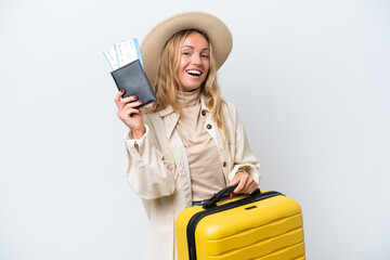 Young Russian woman isolated on white background in vacation with suitcase and passport