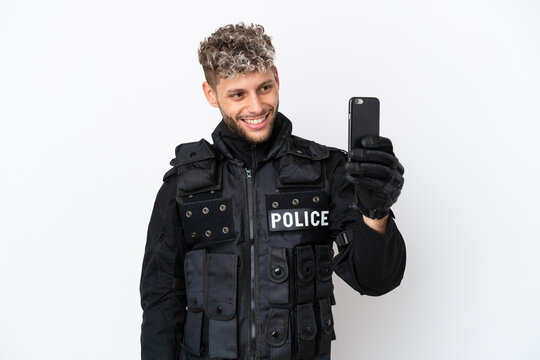 SWAT caucasian man isolated on white background making a selfie