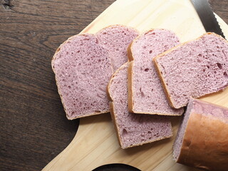 slice of purple sweet potato bread loaf on wooden board