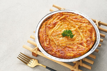 Baked Macaroni Schotel in an aluminium foil cup. Selective focus.
