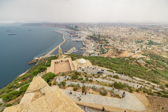 Panoramic view of blessed virgin mary church from Santa Cruz fortress, one of the three forts in Oran, the second largest port of Algeria; Summer day, looking from high above towards the city.