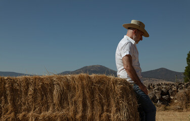 Naklejka na ściany i meble Adult man in cowboy hat in fields. Castilla y Leon, Spain