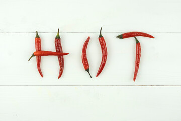 red very hot chillies spelling the word 'hot' on white background
