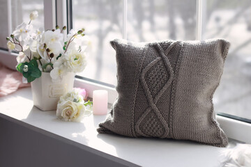 Beautiful soft pillow near the window.