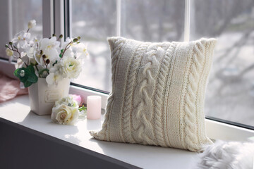 Beautiful soft pillow near the window.