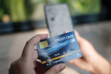 woman holding credit card and use phone for with shopping online. Online payment concept. - Image