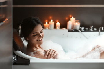 Obraz na płótnie Canvas Happy beautiful woman taking bubble bath. Romantic atmosphere