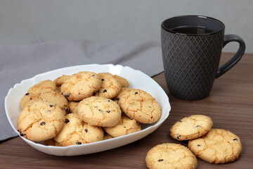 Delicious cookies and aromatic tea on wooden table, closeup