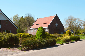 Christian church in cozy suburban neighborhood on sunny day