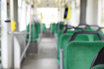 Blurred view of public transport interior with comfortable green seats © New Africa