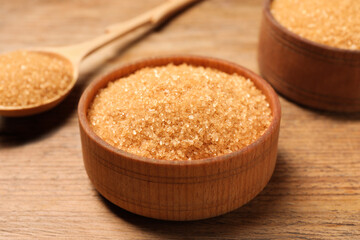 Different dishes with brown sugar on wooden table, closeup