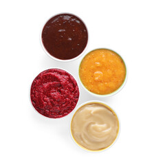 Different fruit and berry puree in bowls on white background, top view