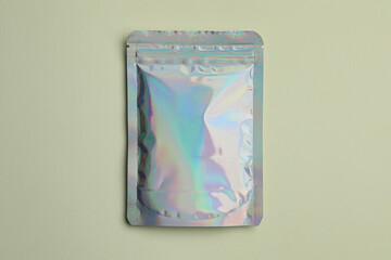 Blank foil package on light background, top view