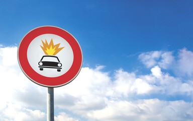 Round car sign transit prohibited for vehicles carrying explosive substances on a blue sky background. Car road sign, prohibition red sign.