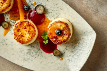 Ukrainian syrniki with jam and berries. Selective focus, close-up