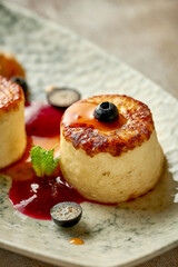 Ukrainian syrniki with jam and berries. Selective focus, close-up