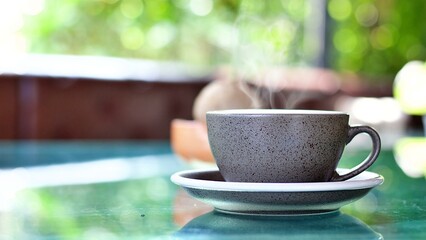 Hot coffee on table with blur background.