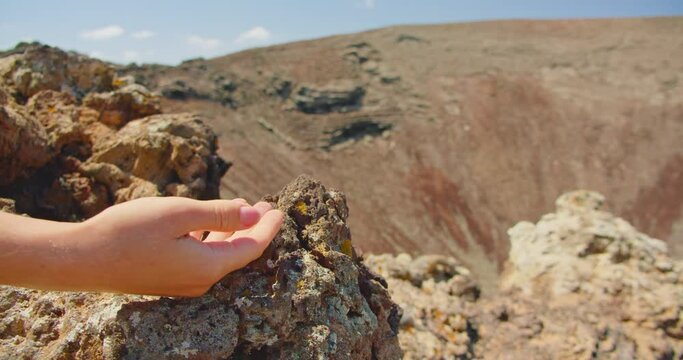 Point of view of a tourist, human hand feeding a squirrel at the Calderon Hondo volcano in Fuerteventura, Canary Islands. Slow motion, close up.