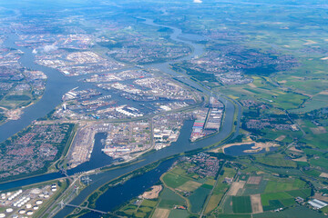 Aerial view of marshlands, coastal town with commercial and industrial harbor and ships from an airplane.
Amsterdam, North Holland, The Netherlands