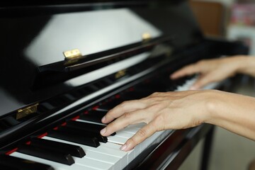 side photo A man plays and practices piano in a music room at school. favorite classical music Show...