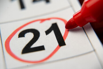 The calendar 21st of the month is circled. A red marker circles the twenty-first day of the month...