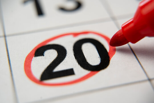 The calendar 20th day of the month is circled. A red marker circles the twentieth day of the month from the paper calendar. A very important date in the calendar