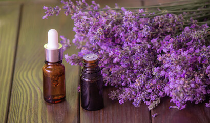 Obraz na płótnie Canvas Essential oil of lavender, on a wooden background.