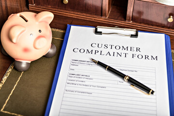 Complaints. Wooden gavel and books in background. Law and justice concept.