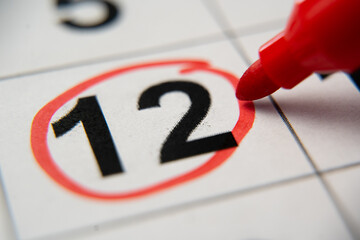 The calendar 12th day of the month is circled. A red marker circles the twelfth day of the month...