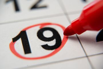 The calendar 19th day of the month is circled. A red marker circles the nineteenth day of the month...