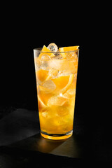 Fresh orange beverage on black background