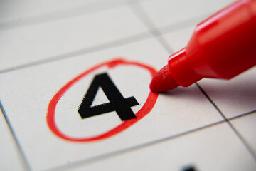 The calendar 4th day of the month is circled. A red marker circles the fourth day of the month from...