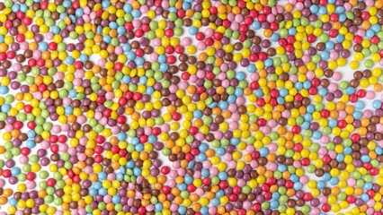 Fototapeta na wymiar Multi-colored round candies dragee texture background