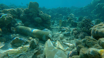 Seabed of beautiful coral reef covered with plastic and other garbage, Red sea, Egypt