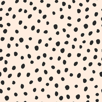 Fototapeta Cute black hand drawn polka dot on beige background. Vector seamless jumble brush spots pattern. Random dots, circles, animal skin. Design for fabric, wallpaper, textile, wrapping paper, packaging.