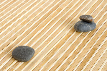 bamboo mat texture with zen pebbles