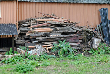 Metal Building and Stack of Old Timber in Deserted Railway Siding 